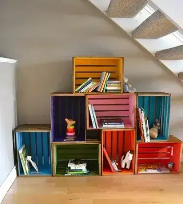 Decoração com caixotes de madeira organizando livros infantis e brinquedos Foto de Robert Arnold
