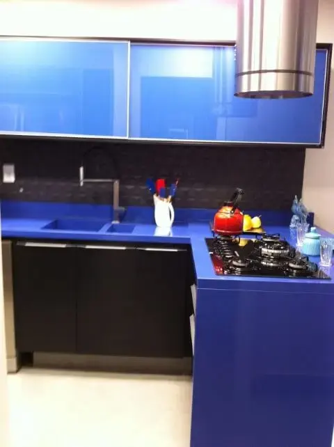 Cozinha colorida com armários e bancada azuis Projeto de Ana Cristina Nigromalta