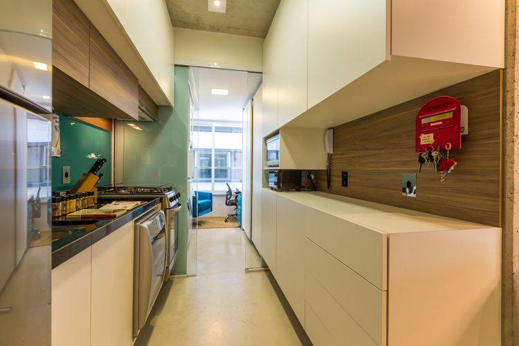 Cozinha compacta do tipo corredor com home office no final Projeto de By Arq Design