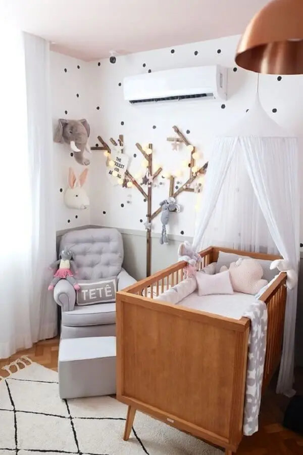 quarto de bebê decorado com berço de madeira e poltrona de amamentação com puff cinza Foto Casa de Valentina