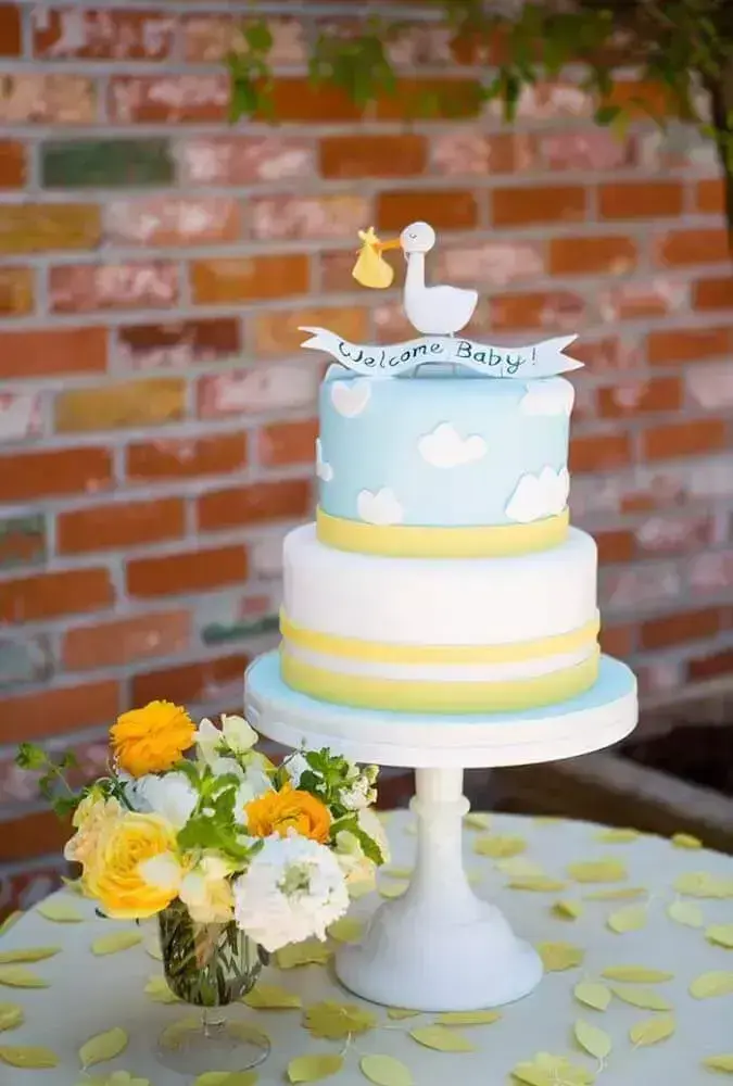 baby tea cake with little stork on top Photo Style Me Pretty