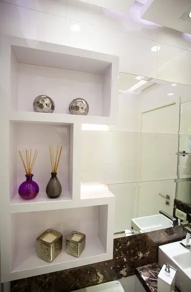 Decoração de banheiro com uso de nichos ao lado do espelho Projeto de Graça Brenner