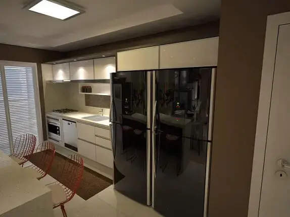 Cozinha planejada com armários e eletrodomésticos perfeitamente encaixados Projeto de Ednilson Hin