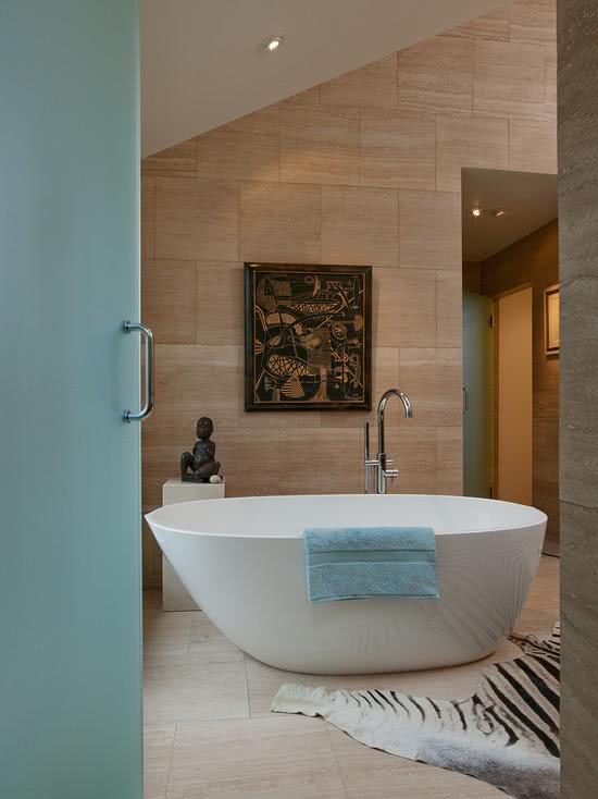 Banheiro com banheira branca oval e decoração moderna