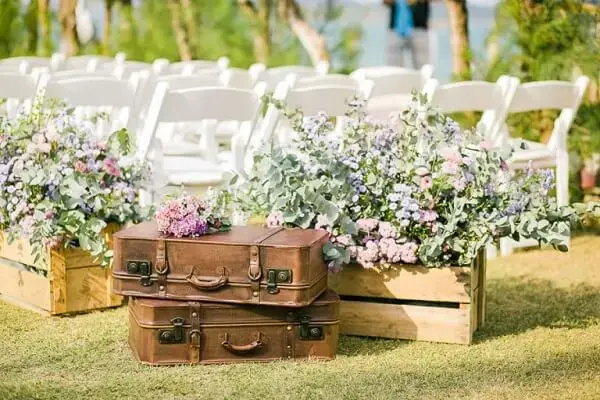 Leather bags and wooden crates are part of simple wedding decoration