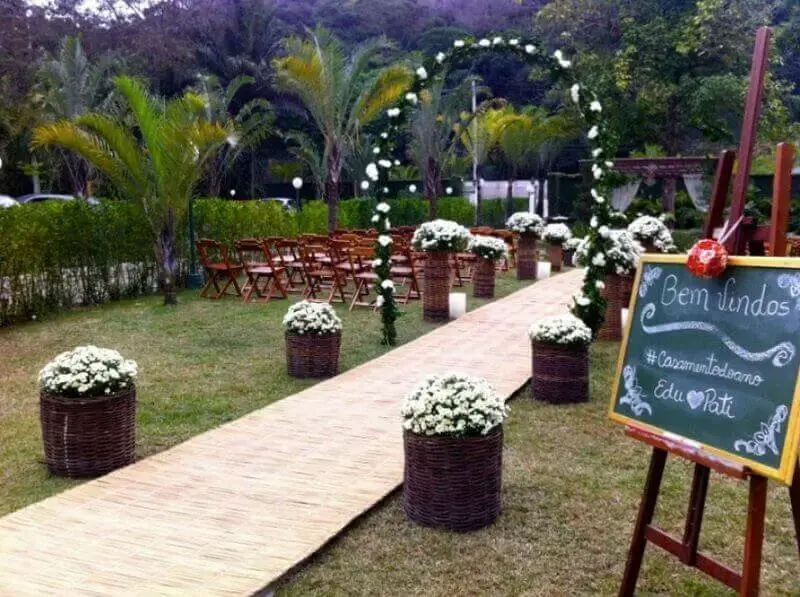 simple outdoor wedding decoration with baskets of flowers