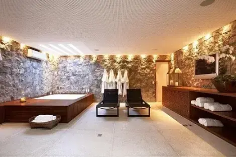 Banheiro de luxo com espreguiçadeiras Projeto de Fernanda Pessoa de Queiroz