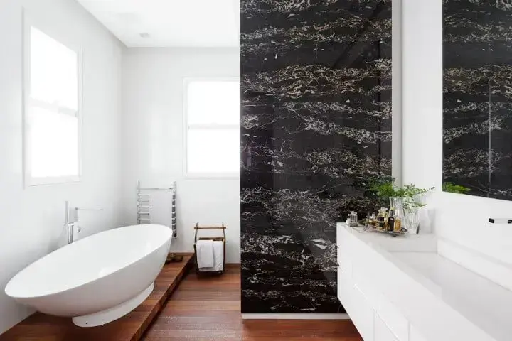 Banheiro de luxo com parede revestida de mármore preto Projeto de Consuelo Jorge