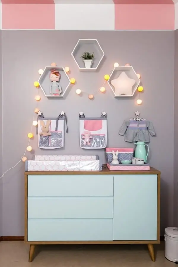 O cordão de luz ilumina e traz um toque diferenciado para o quarto de bebê com cômoda retrô. Fonte: Pinterest