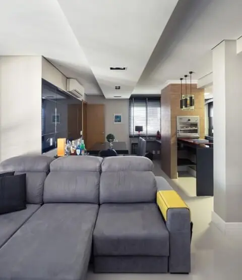 Sala de estar com sofá retrátil cinza Projeto de Braccini Lima
