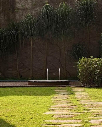 Jardim com ofurô próximo à piscina Projeto de Rodrigo Oliveira