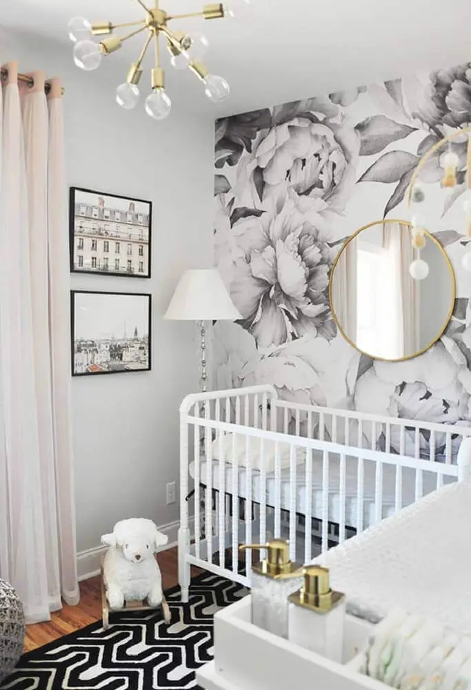 decoração moderna para quarto de bebê pequeno com papel de parede floral e espelho redondo
