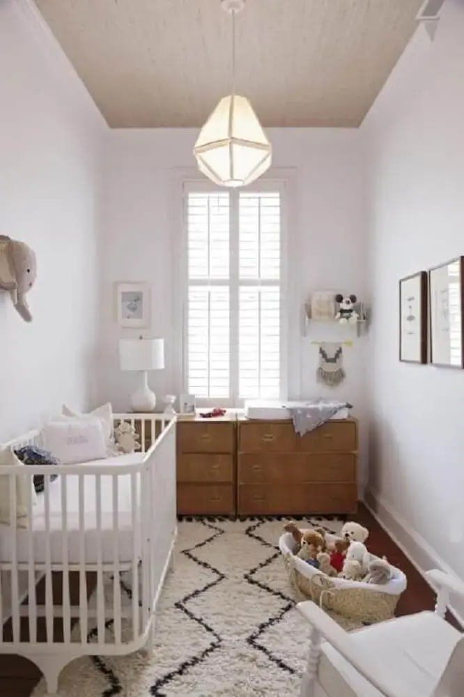 quarto de bebê simples e pequeno com tapete branco e preto