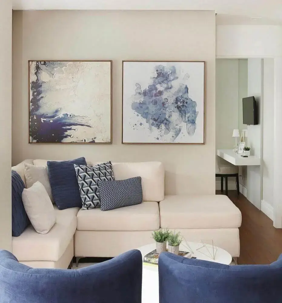 sala com sofá de canto bege e almofadas azuis