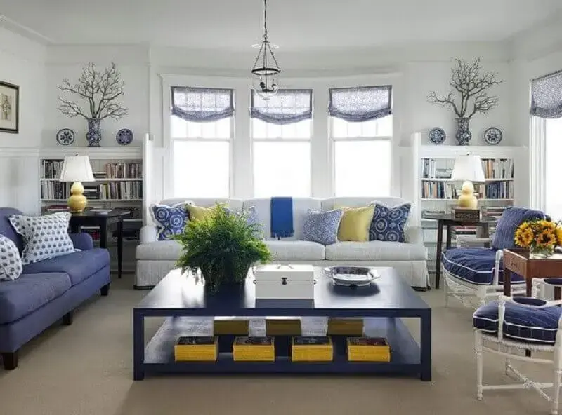 Sala de estar com mesa móveis e cortinas em azul royal Foto Militant Vibes