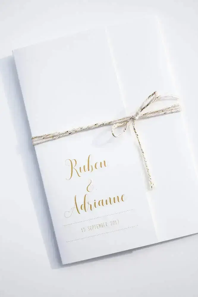 convite simples de casamento com letras douradas e laço feito com corta para fechar 