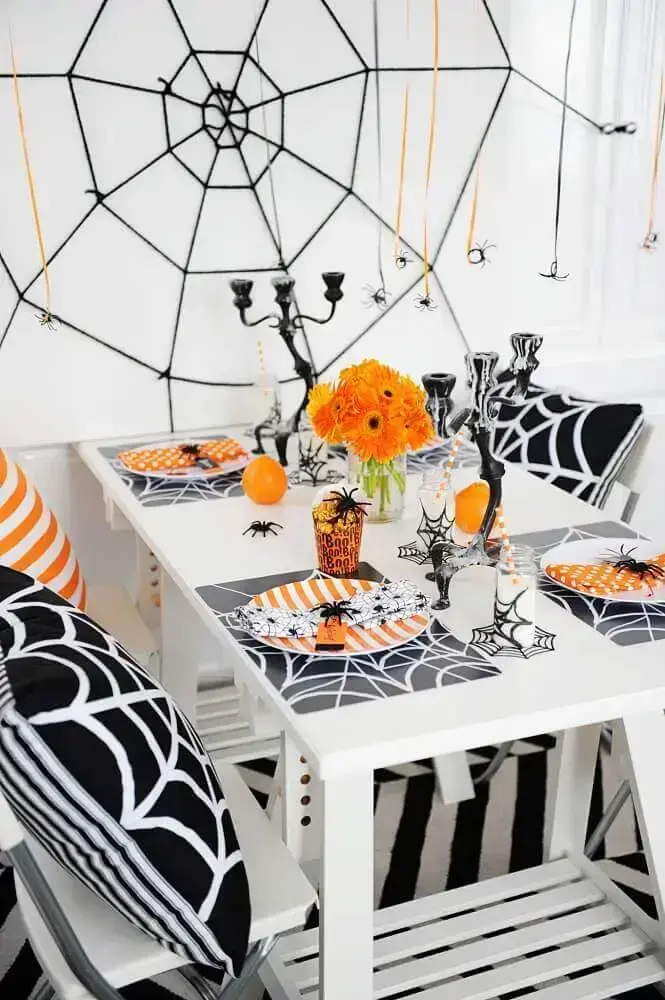 shades of orange arm and black for Halloween decoration with large web on the wall Photo Notey