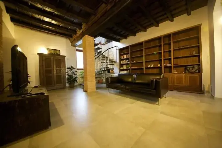 Sala de estar com sofá de couro preto e pés de metal Projeto de Gabriele Barotto