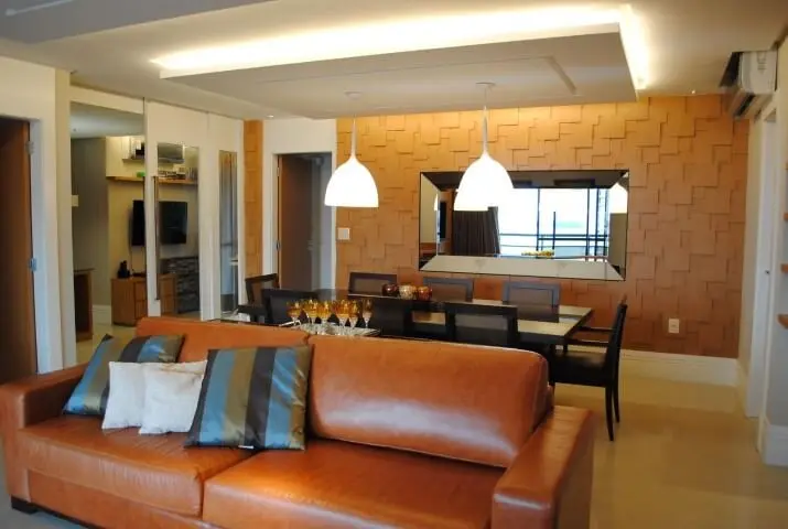 Sala integrada com sofá de couro marrom e almo