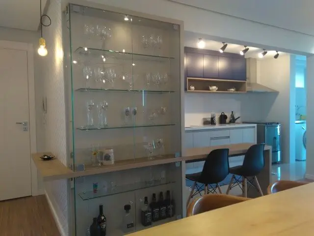 Cozinha americana com cristaleira moderna de vidro com taças e copos Projeto de Vanessa Lora