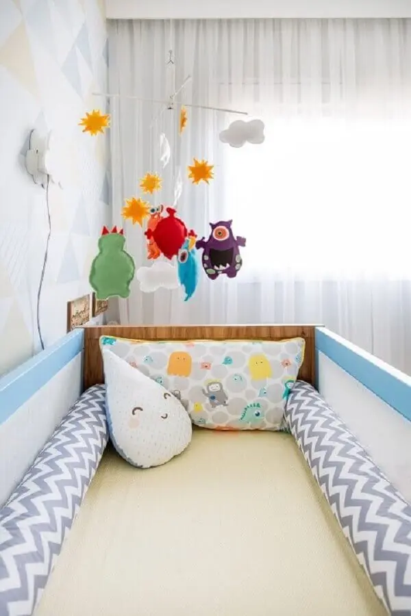 decoração alegre com enfeites para quarto de bebê com berço azul Foto Studio Novak