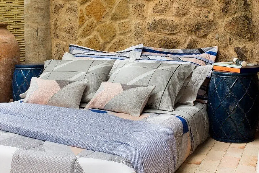 cama decorada com vários travesseiros e bonita roupa de cama