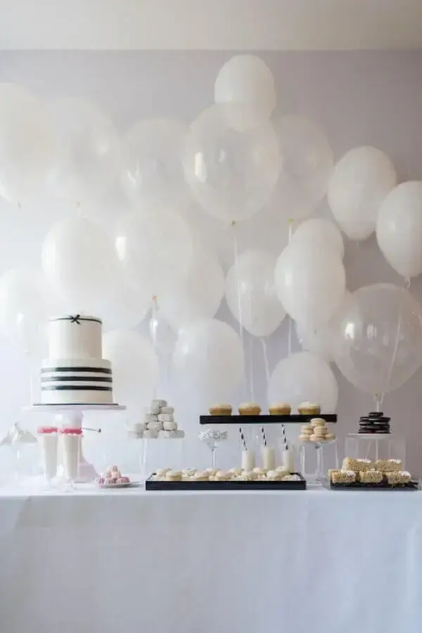 Birthday party decoration with white balloons and black and white cake Photo Urban Flip Flops