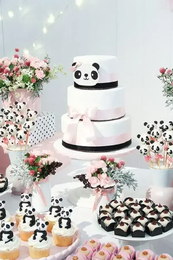 delicate black and white birthday party decor with three tier panda bear themed cake Photo Constance Zahn