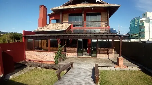 Casa rústica com varanda de piso de madeira
