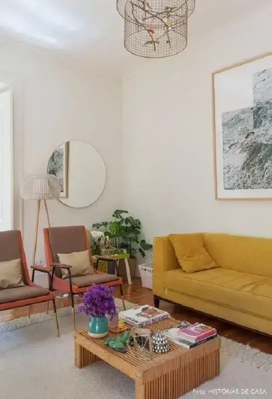 decoração simples com espelho redondo para sala com sofá amarelo Foto Histórias de Casa