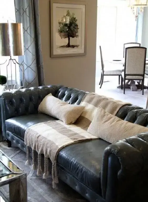 sofá chesterfield - sofá chesterfield marrom de couro com manta em sala de estar