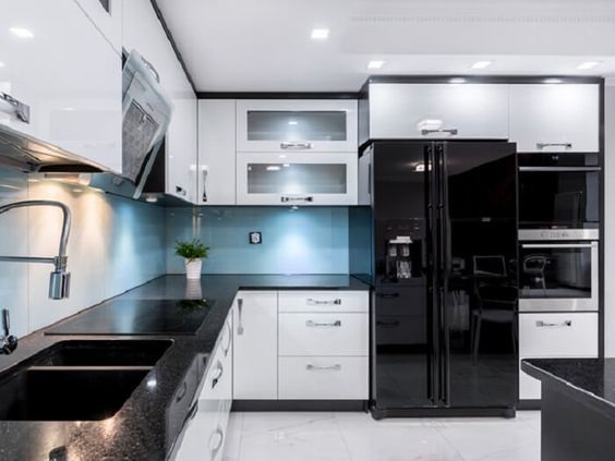 Geladeira preta moderna na cozinha branca