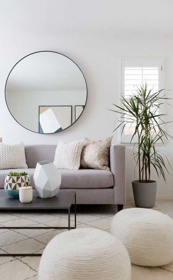 Espelho decorativo redondo para sala de estar decorada com sofá cinza e puffs brancos Foto Pinterest