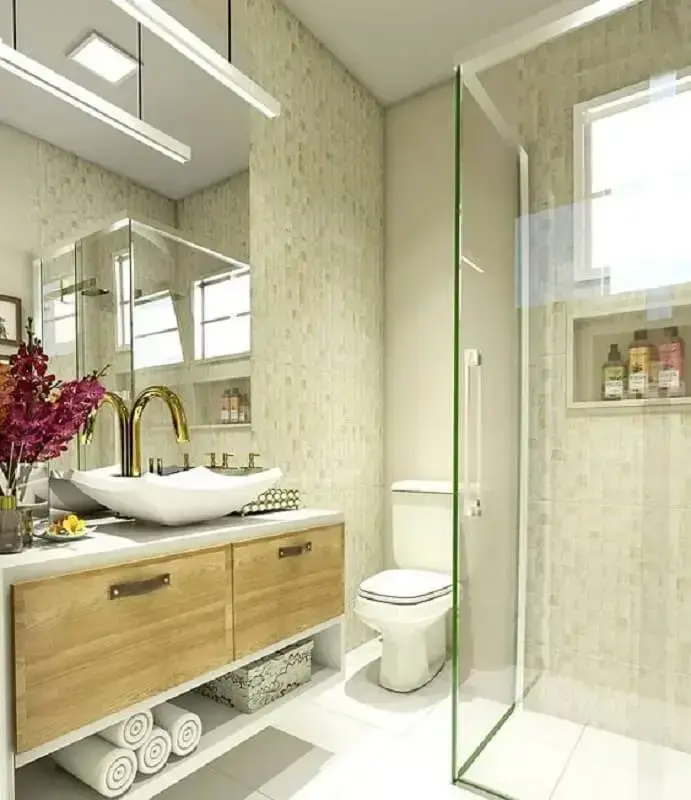 banheiro feminino decorado com armário suspenso e torneira dourada Foto ArqA2 Arquitetura & Interiores