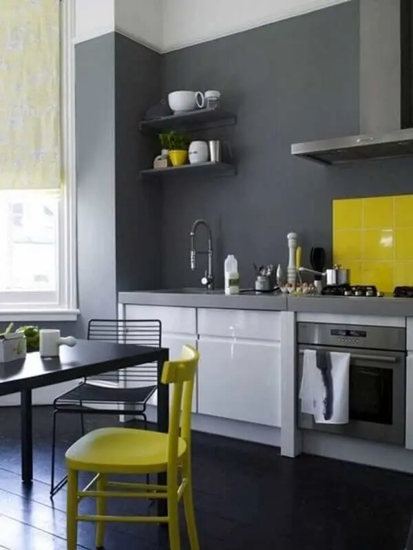 cozinha cinza e amarela decorada com móveis planejados e cadeiras diferentes Foto Archidea