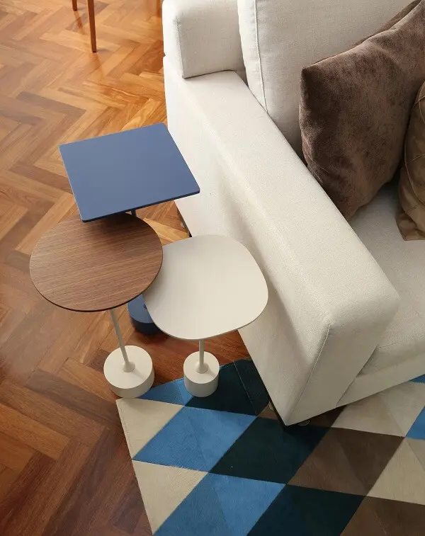 Mesa de canto e tapete geométrico colorido encanta a decoração do espaço