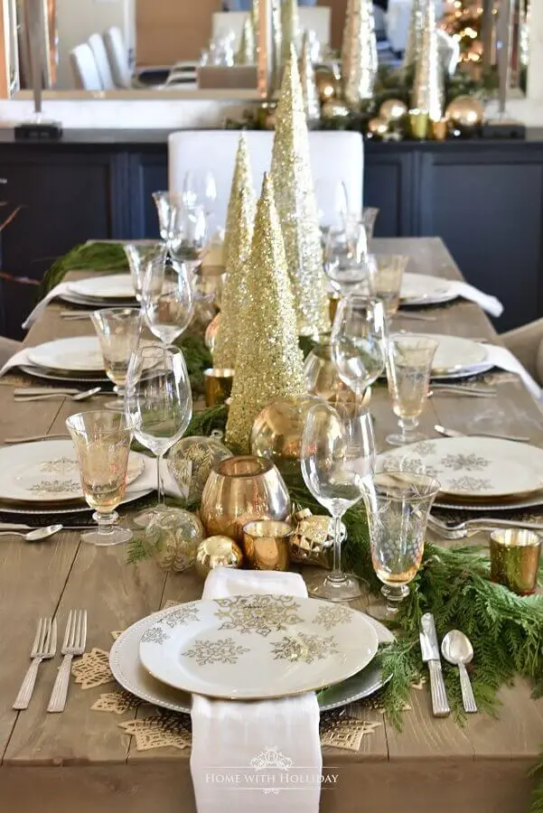 decoração mesa réveillon com folhagens e pequenos pinheiros dourados Foto Home With Holliday