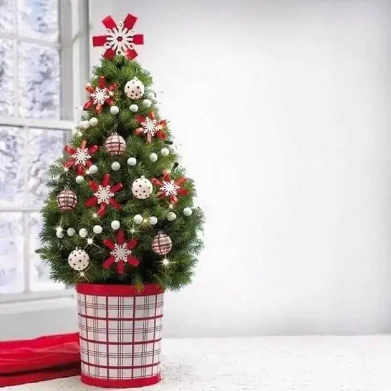 Small Christmas tree decorated with red ornaments Photo ProFlowers