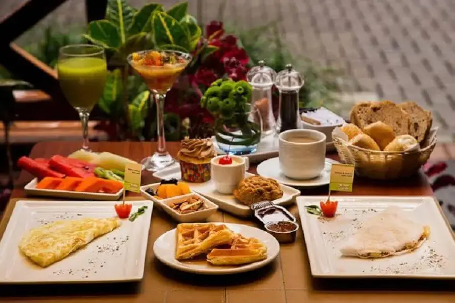 mesa de café da manhã com frutas e cestas de pães Foto Bem Paraná