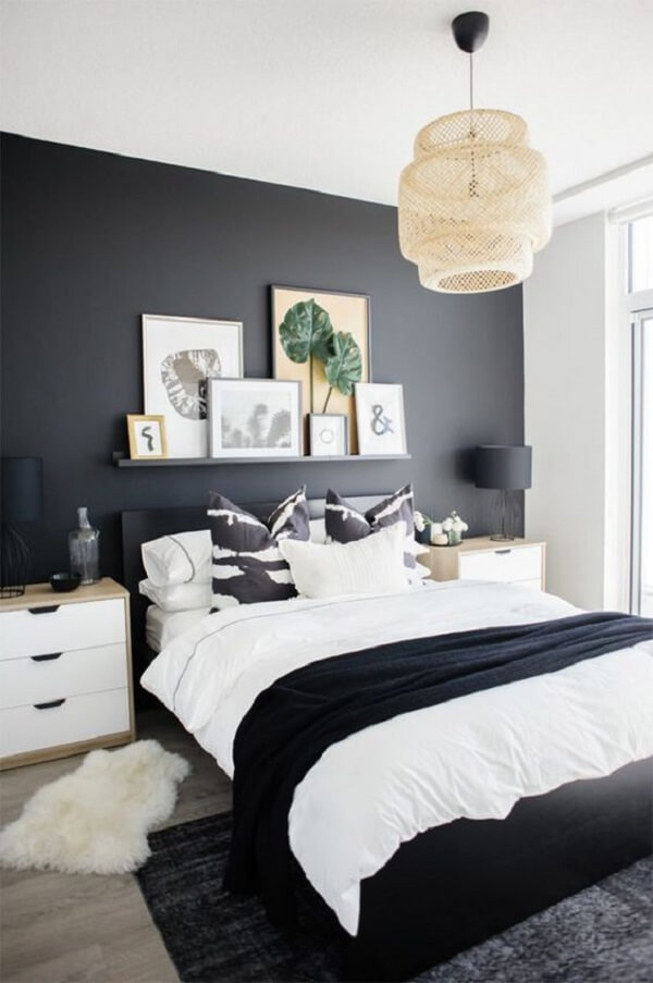 Quarto com decoração minimalista com parede preta e branca