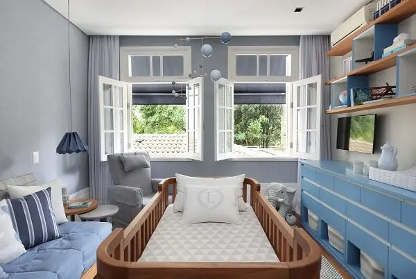 Quarto de bebê cinza e azul com duas janelas 