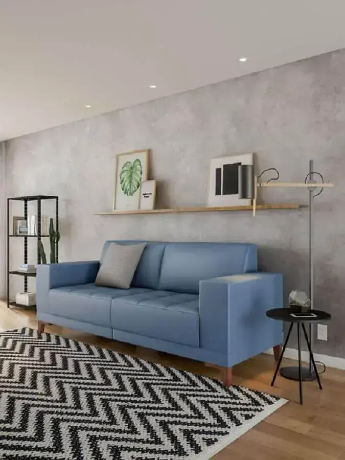 sofá azul claro para decoração de sala com parede de cimento queimado Foto Arquidicas