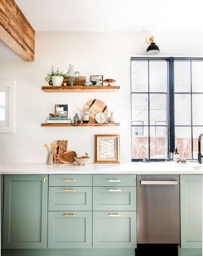 Cozinha com bancada ampla e armários em tom verde menta