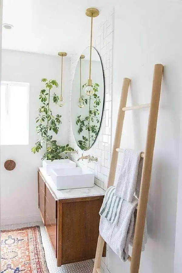decoração com plantas no banheiro clean com gabinete de madeira e pendente dourado Foto Pinterest
