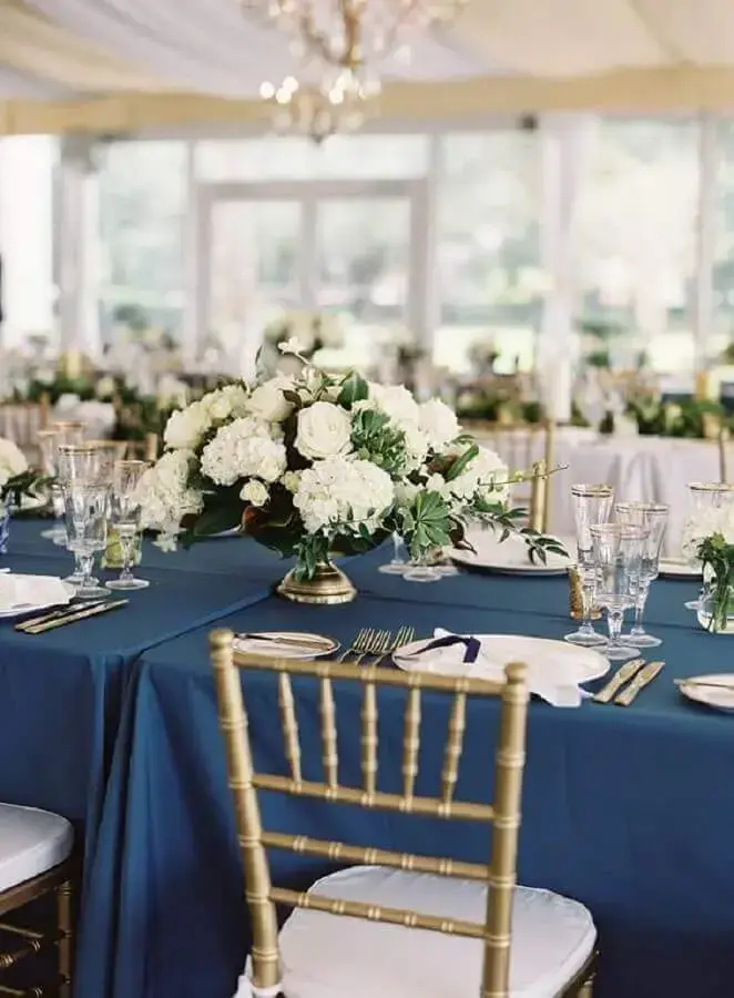 blue and gold wedding decoration with white flower arrangements Photo Style Me Pretty
