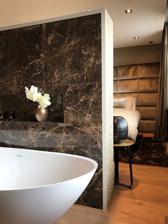 Porcelanato marmorizado marrom no banheiro, combinando com o quarto