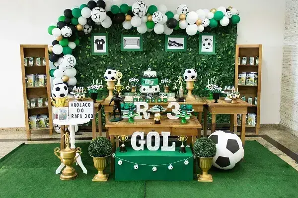 Synthetic grass on the floor and wooden furniture bring style to football theme birthday party