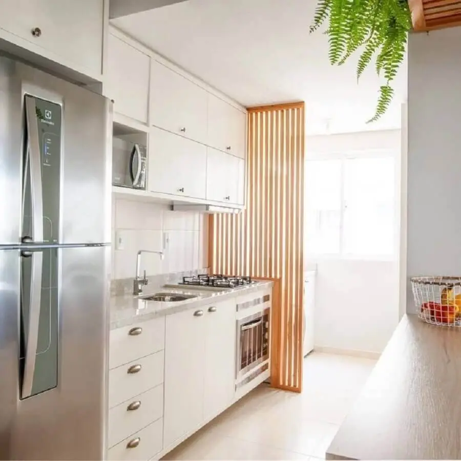 cozinha de apartamento planejada branca com divisória de madeira Foto Boreal Arquitetura