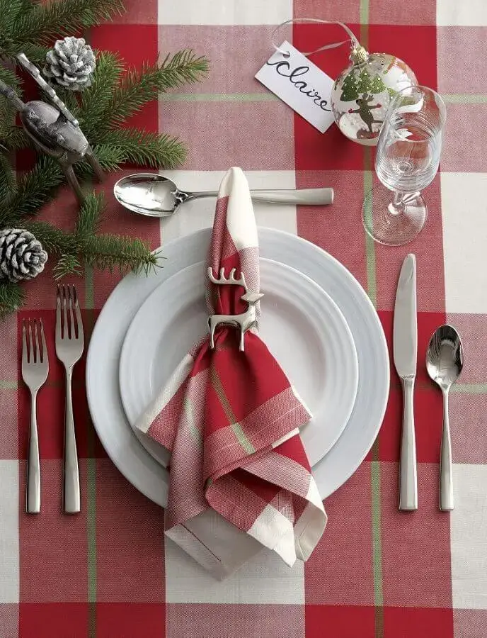 Christmas table decoration with plaid tablecloth and napkin and reindeer clip for napkin Photo Crate and Barrel
