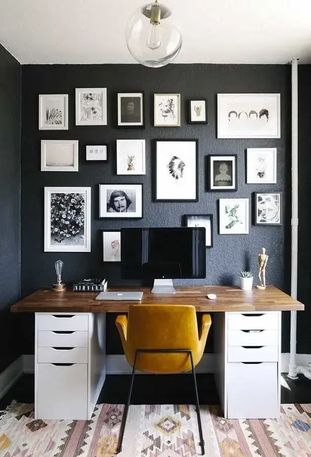 mesa para home office decorado com vários quadros em parede preta Foto Home Decor